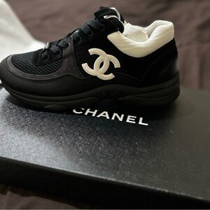 Authentic never been worn black and white Chanel sneakers. Comes with the box.